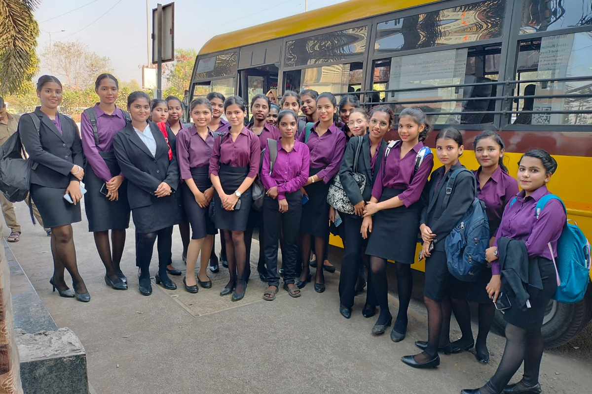 A Centuria batch in uniform in front of a bus during an industry visit