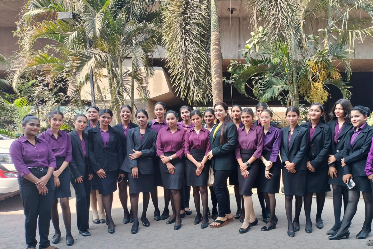 A full Centuria batch in purple shirts and black blazers standing outdoors